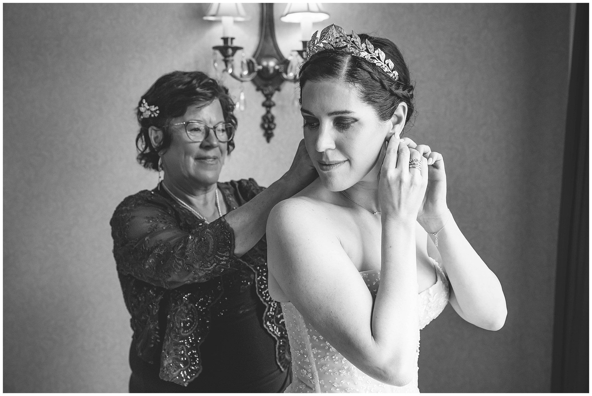 bride and her mother putting on her earrings